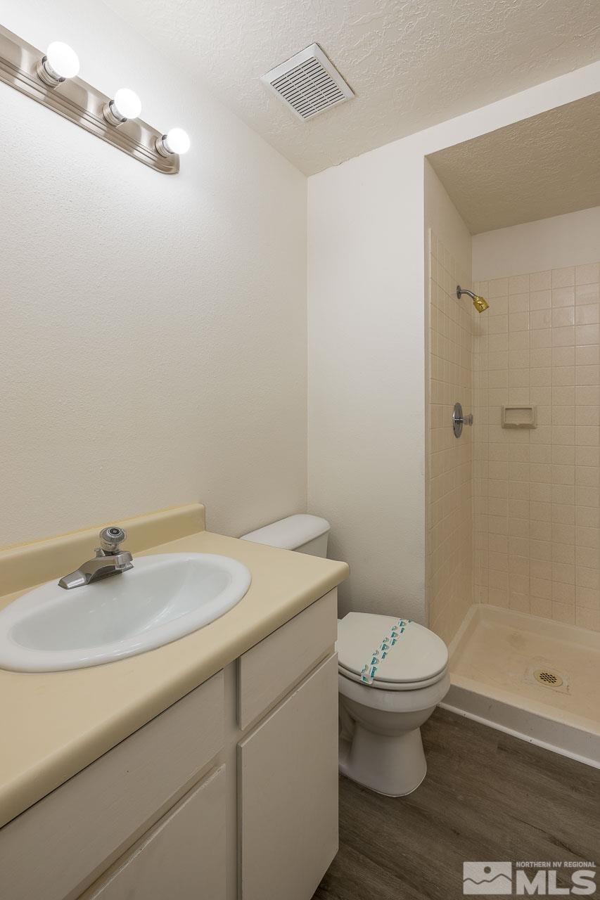 6885 Lotus Street Reno, NV 89506 - Photo 7 of 11 a bathroom with a sink a toilet and shower