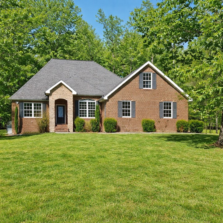 31 Chickory Lane Monteagle, TN 37356 - Photo 4 of 61 a view of a yard in front of a house with plants and large trees