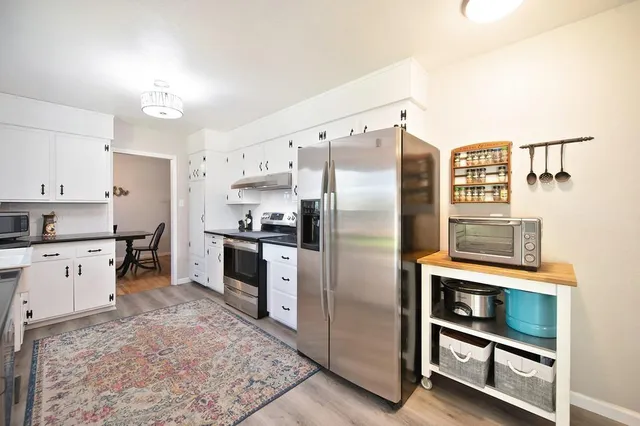 a kitchen with a refrigerator and a stove