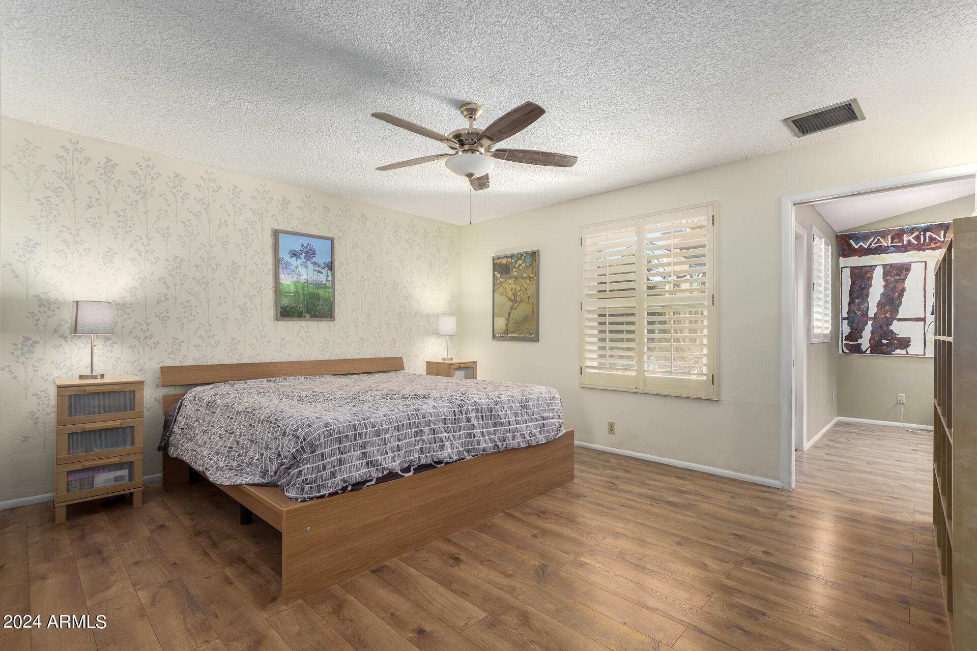 6516 West Mountain View Road Glendale, AZ 85302 - Photo 20 of 35 a bedroom with a bed and a chandelier