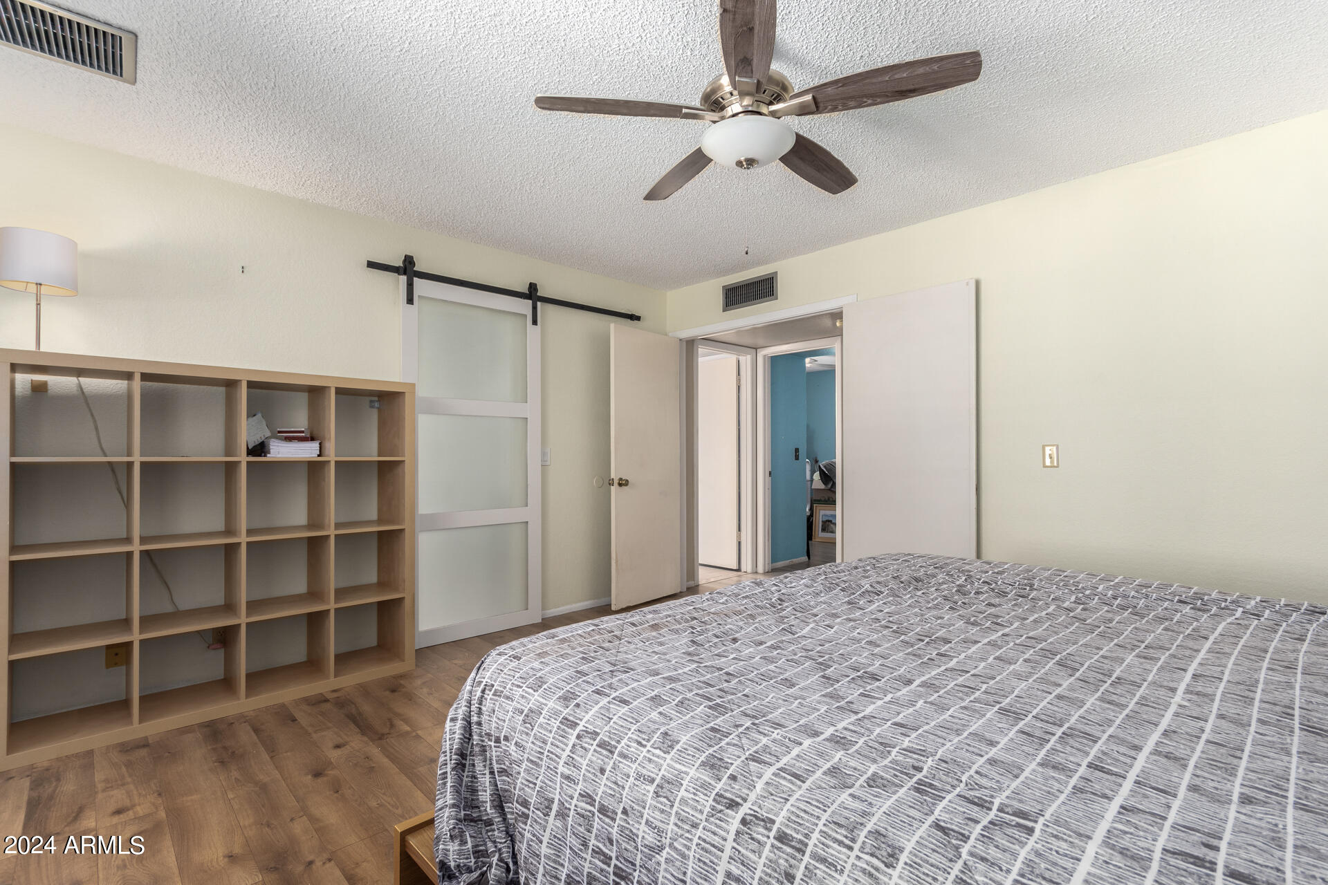 6516 West Mountain View Road Glendale, AZ 85302 - Photo 23 of 35 a bedroom with a bed chandelier and a window