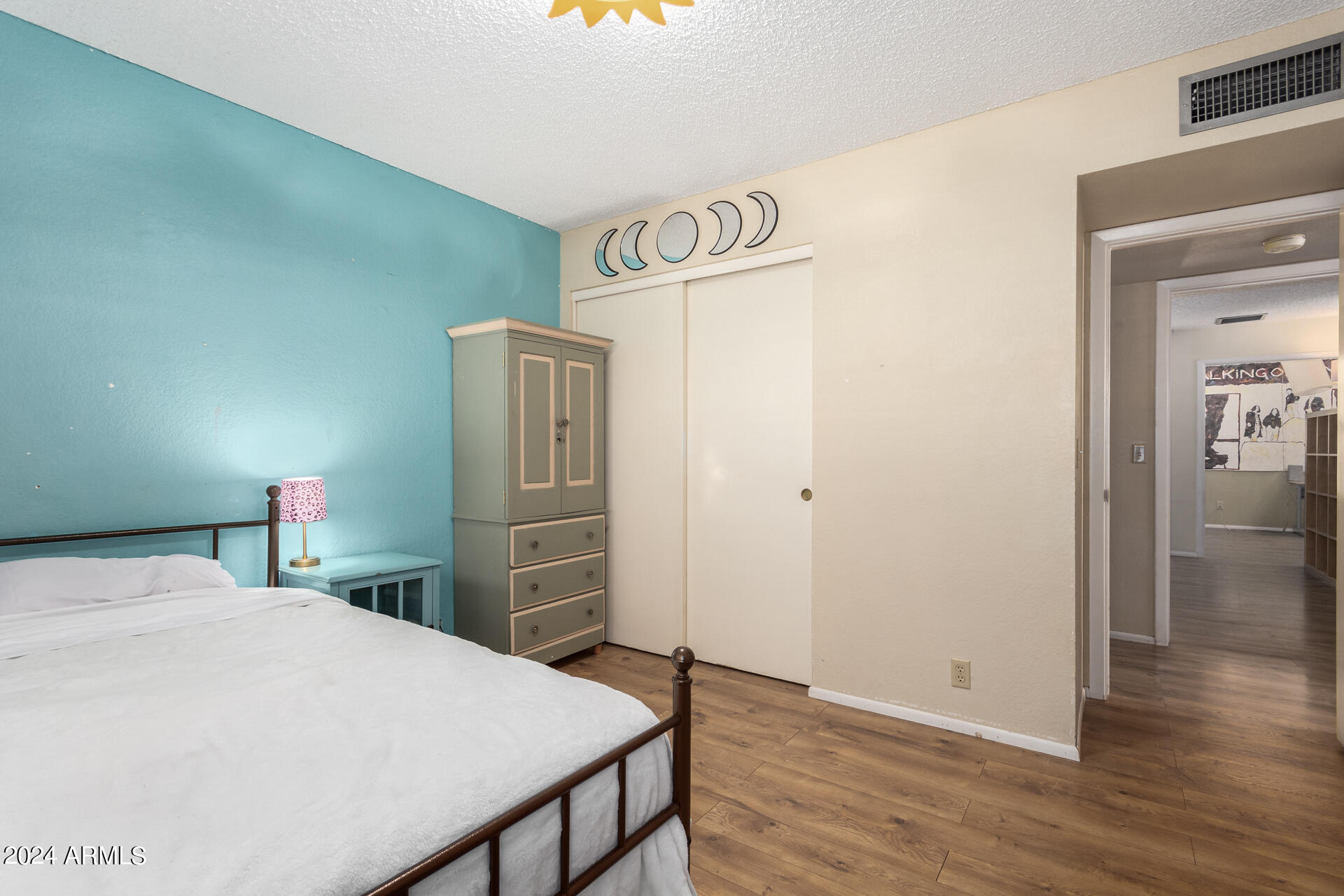 6516 West Mountain View Road Glendale, AZ 85302 - Photo 30 of 35 a bedroom with a bed and wooden floor