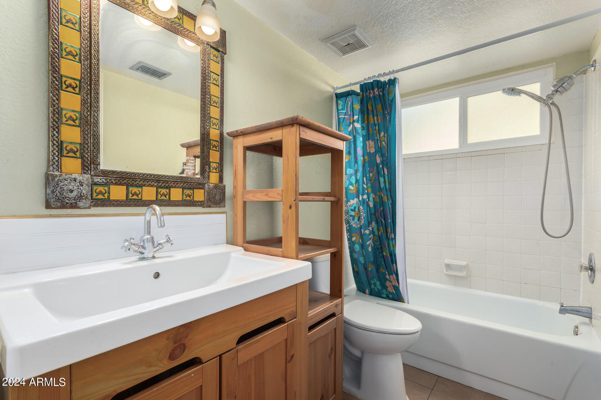 6516 West Mountain View Road Glendale, AZ 85302 - Photo 31 of 35 a bathroom with a sink toilet and shower