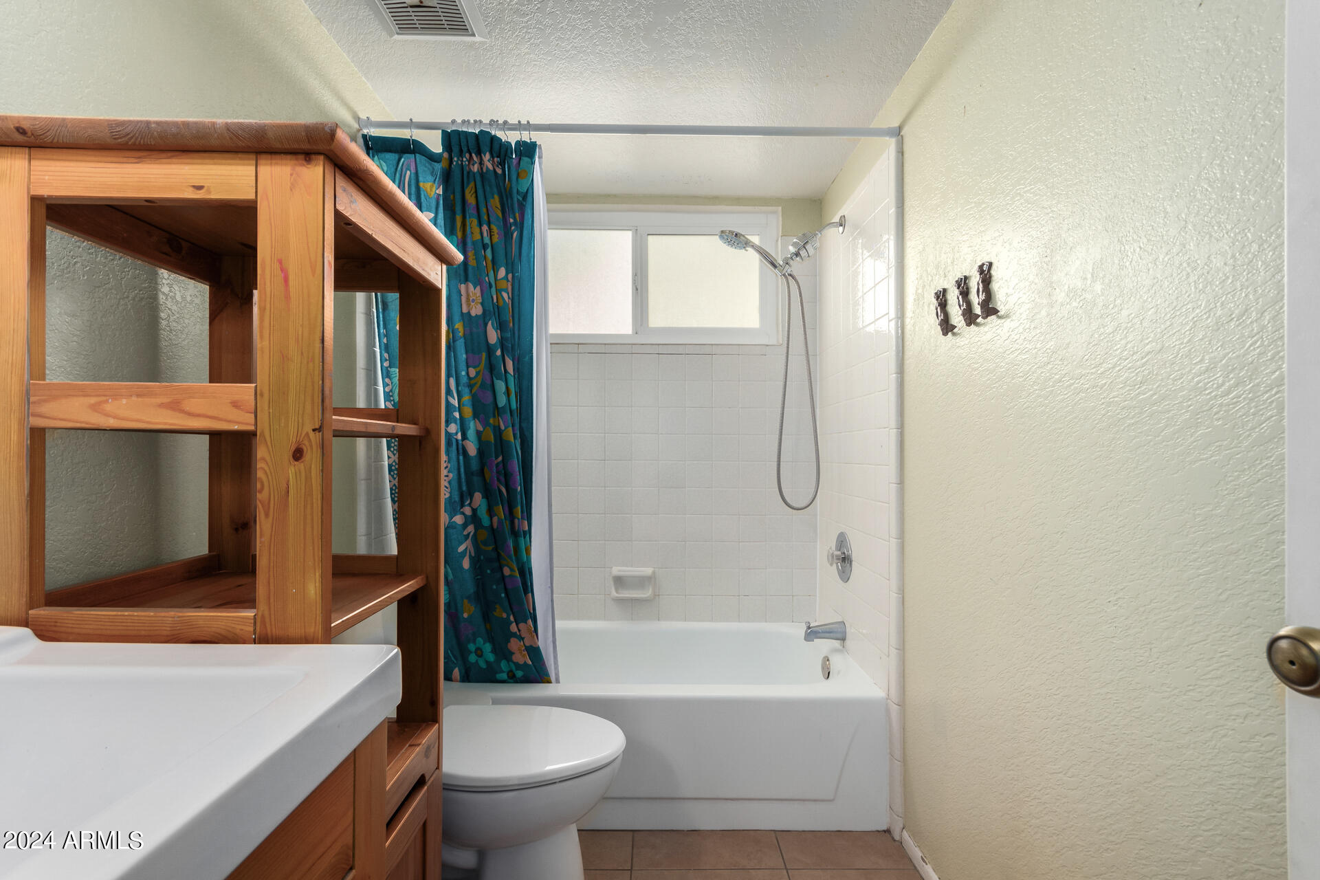 6516 West Mountain View Road Glendale, AZ 85302 - Photo 32 of 35 a bathroom with a bathtub shower sink vanity and toilet