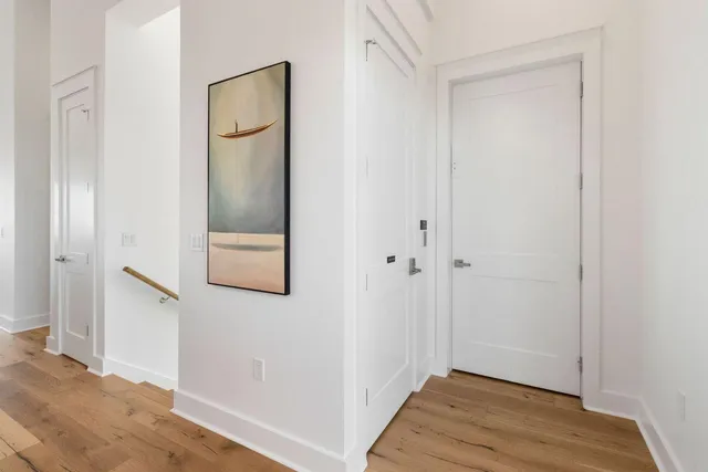 a bedroom with a large bed and a flat tv screen on dresser