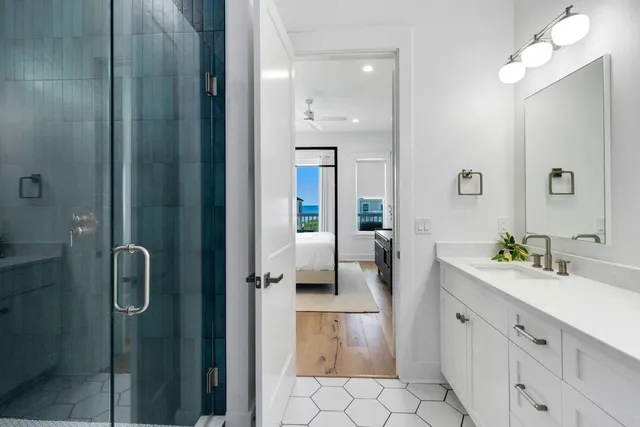 a spacious bedroom with a large bed and a flat tv screen on dresser