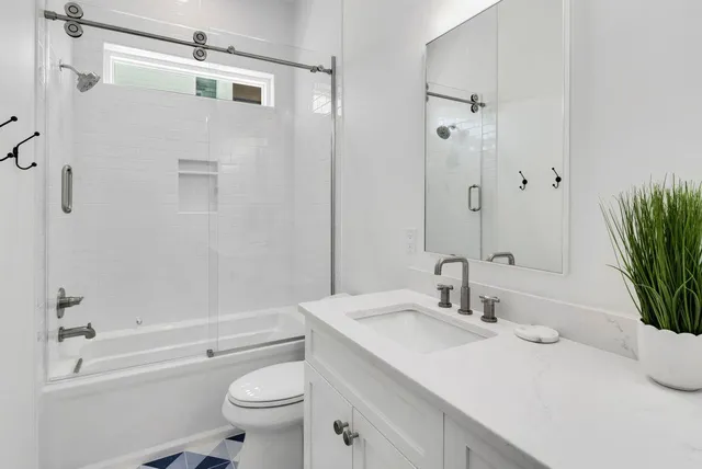 a large bed sitting in a bedroom next to a window