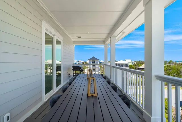 a view of a balcony with chairs and wooden floor