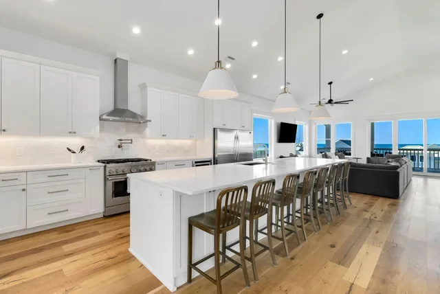 a kitchen with stainless steel appliances granite countertop a sink and a refrigerator