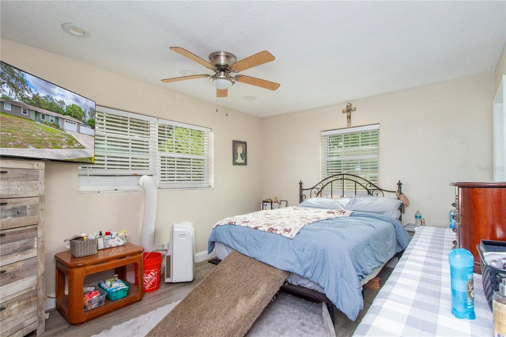 7367 Gates Circle Spring Hill, FL 34606 - Photo 11 of 31 a bedroom with a bed a dresser and a window