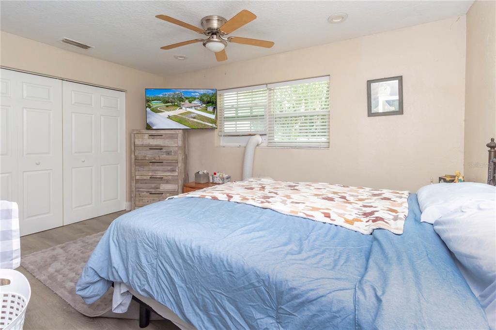 7367 Gates Circle Spring Hill, FL 34606 - Photo 12 of 31 a bedroom with a bed dresser and a window