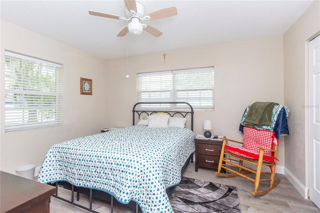 7367 Gates Circle Spring Hill, FL 34606 - Photo 14 of 31 a bedroom with a bed and a chandelier