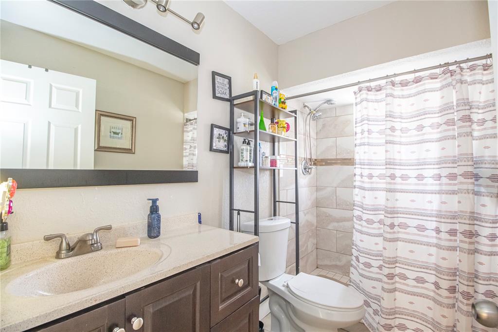 7367 Gates Circle Spring Hill, FL 34606 - Photo 16 of 31 a bathroom with a sink toilet vanity and shower