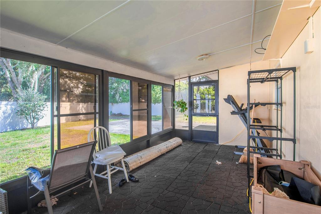 7367 Gates Circle Spring Hill, FL 34606 - Photo 18 of 31 a living room with furniture and a floor to ceiling window
