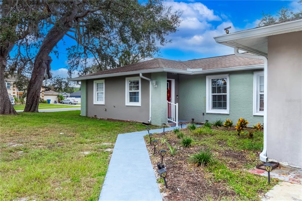 7367 Gates Circle Spring Hill, FL 34606 - Photo 3 of 31 a front view of a house with garden