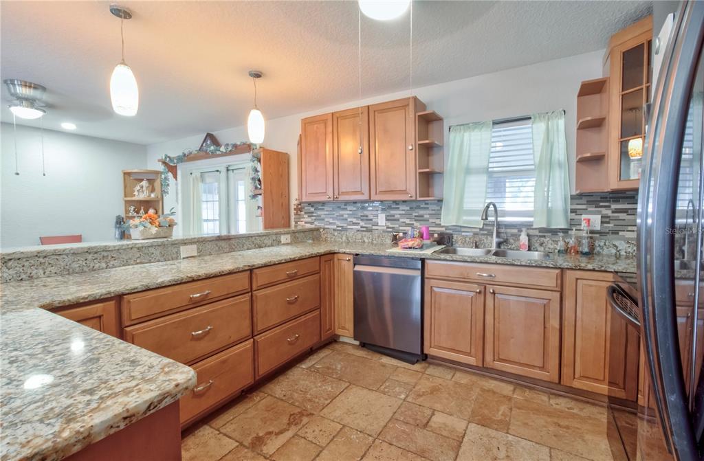 7367 Gates Circle Spring Hill, FL 34606 - Photo 7 of 31 a spacious bathroom with a granite countertop sink and a mirror