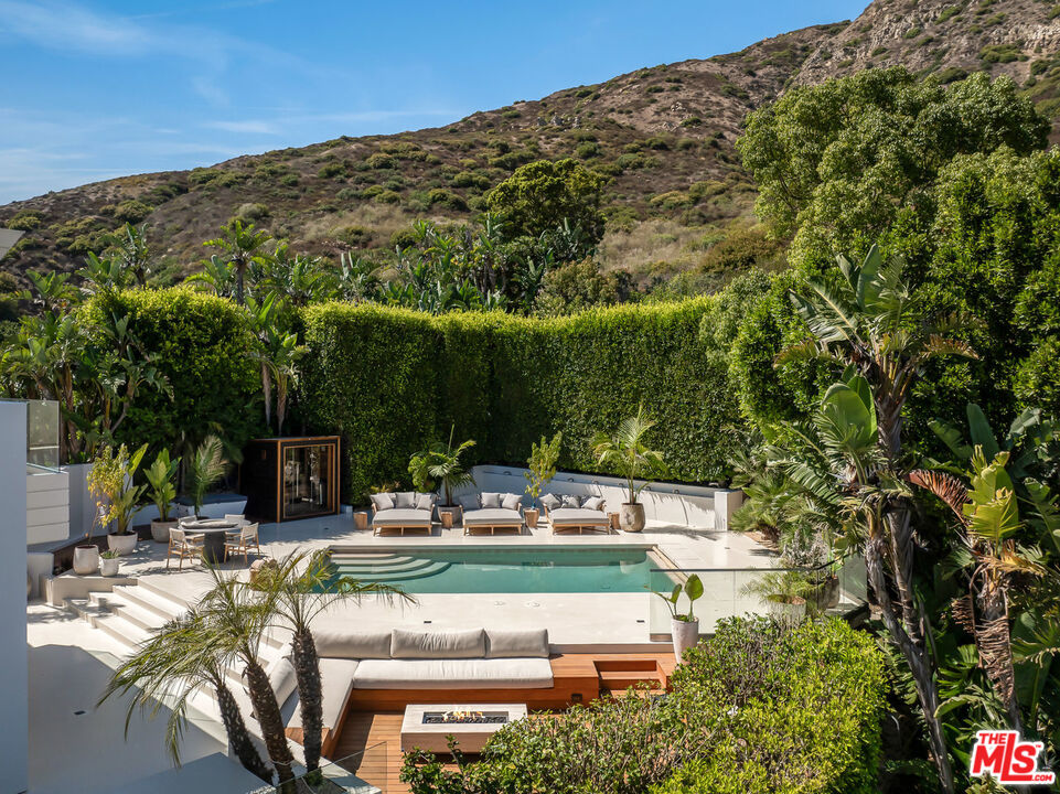 4310 Encinal Canyon Road Malibu, CA 90265 - Photo 21 of 28 a view of a chairs and table in the patio