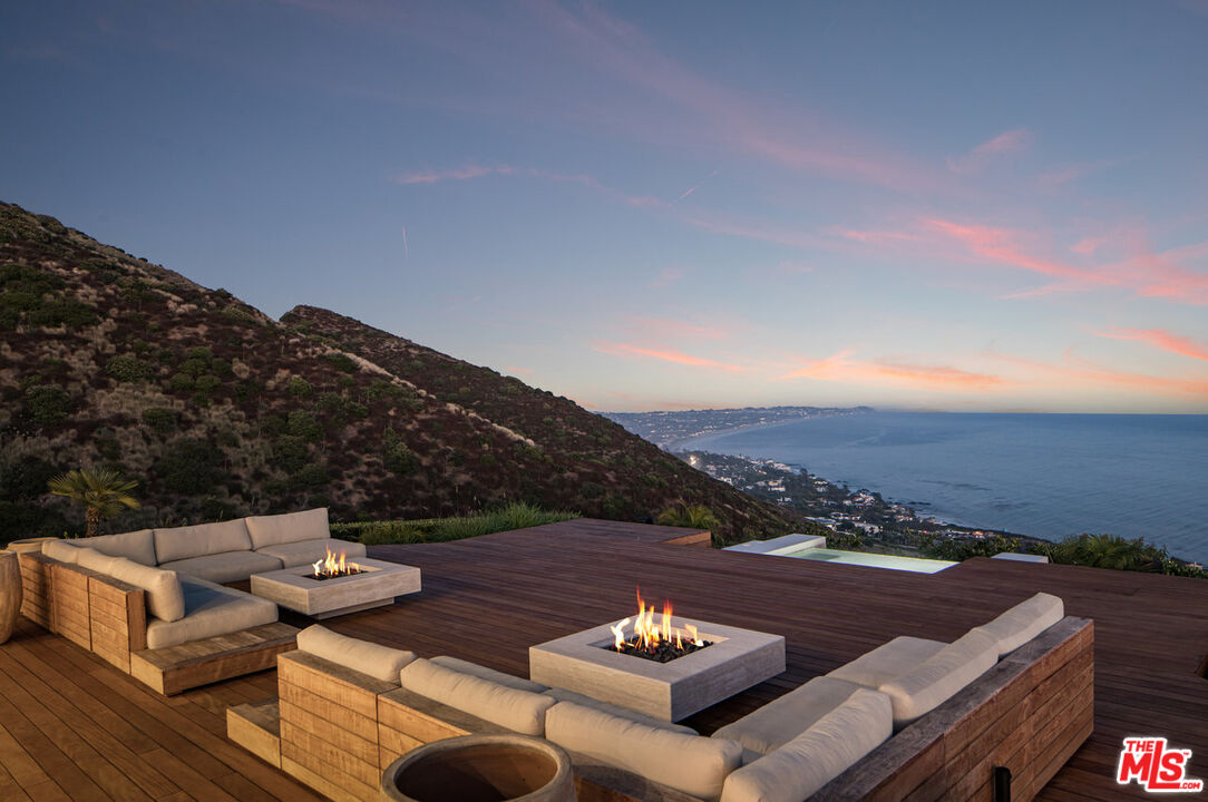 4310 Encinal Canyon Road Malibu, CA 90265 - Photo 23 of 28 a view of a patio with couches table and chairs and potted plants