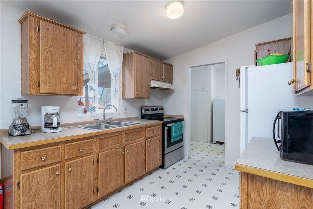1410 Nooksack Road Everson, WA 98276 - Photo 8 of 26 a kitchen with a sink stove and refrigerator