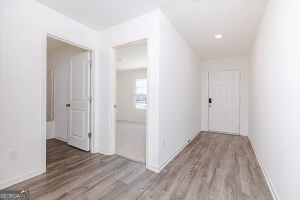 a view of hallway with wooden floor