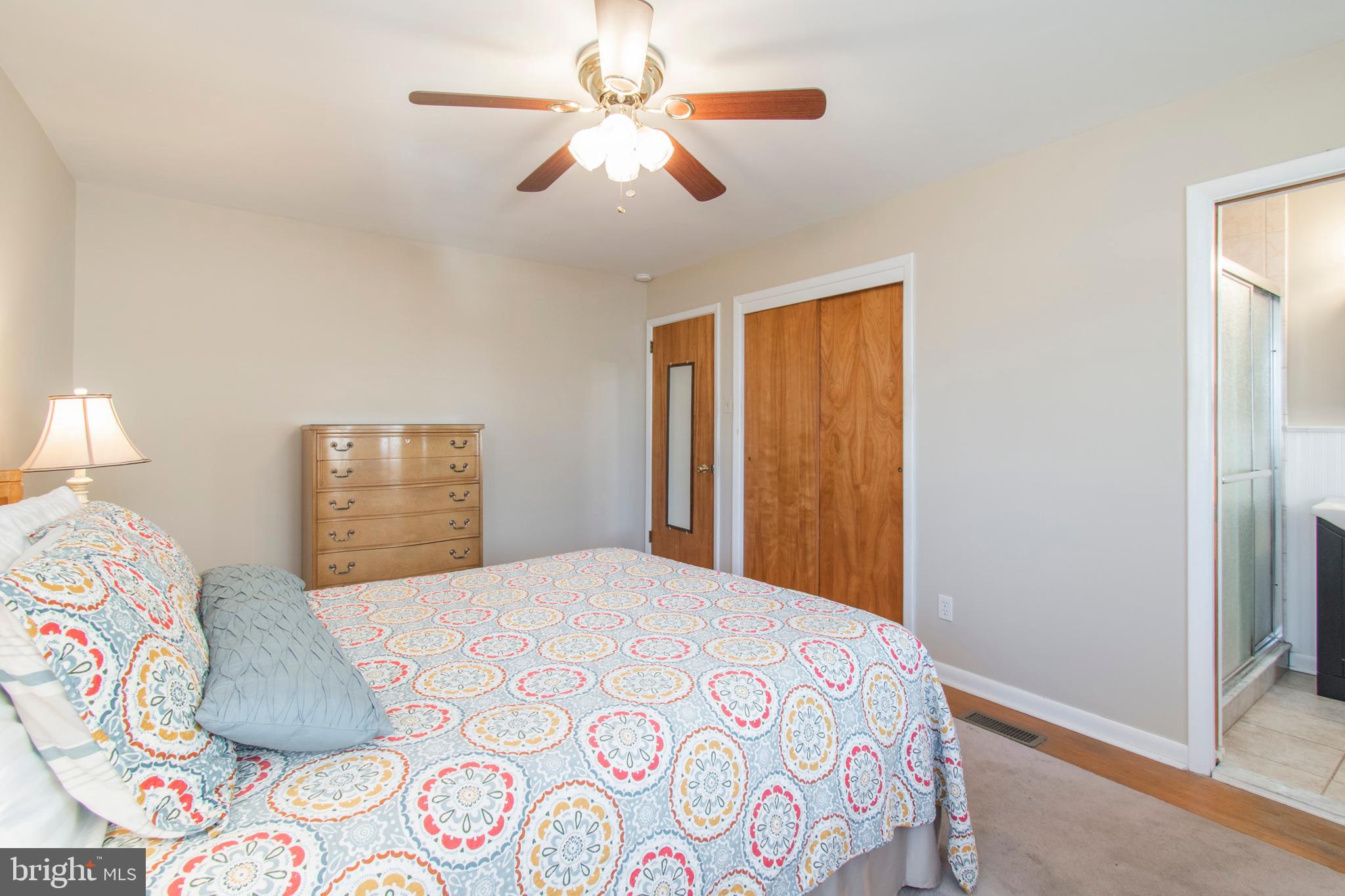 2333 Poplar Road Havertown, PA 19083 - Photo 23 of 38 a bedroom with a large bed and a chandelier