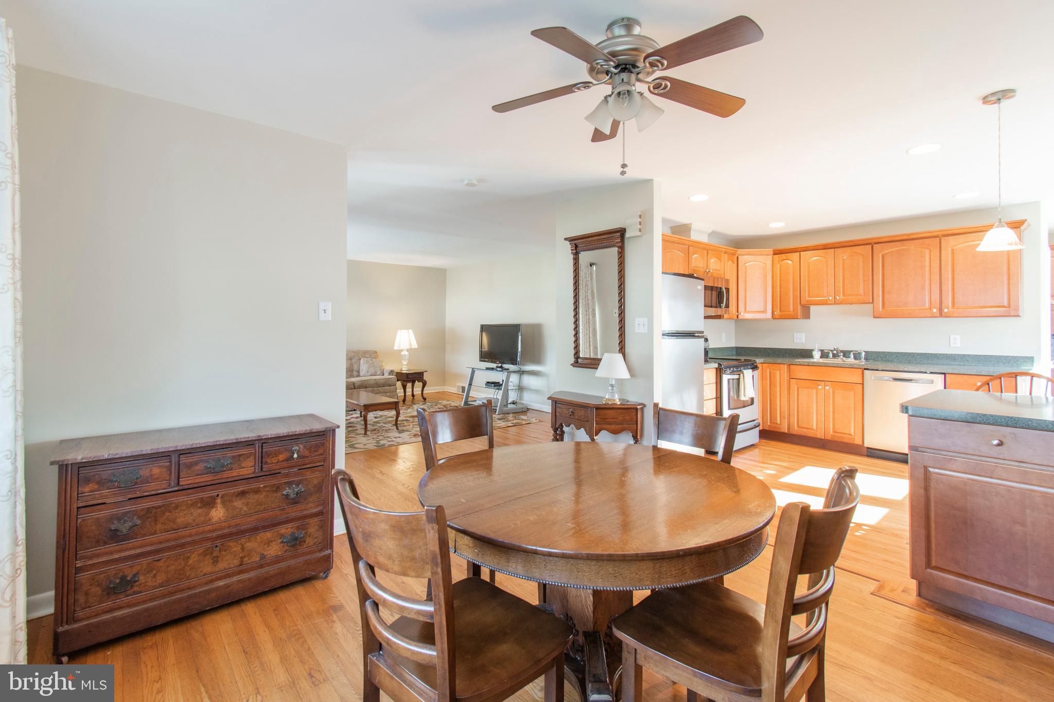 2333 Poplar Road Havertown, PA 19083 - Photo 10 of 38 a dining room with wooden floor a chandelier fan a wooden table and chairs