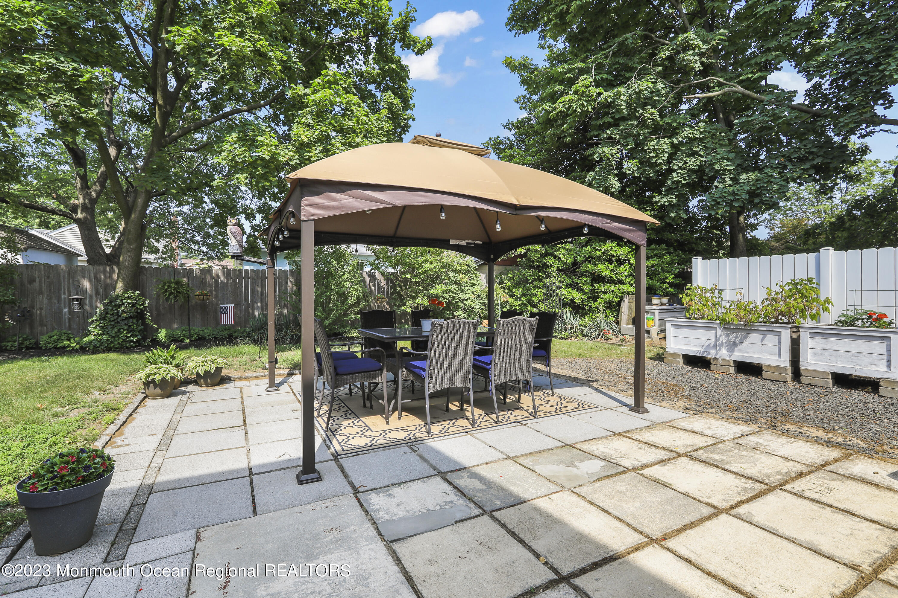 7 Burtina Place Keyport, NJ 07735 - Photo 27 of 29 a view of a patio with a table and chairs under an umbrella