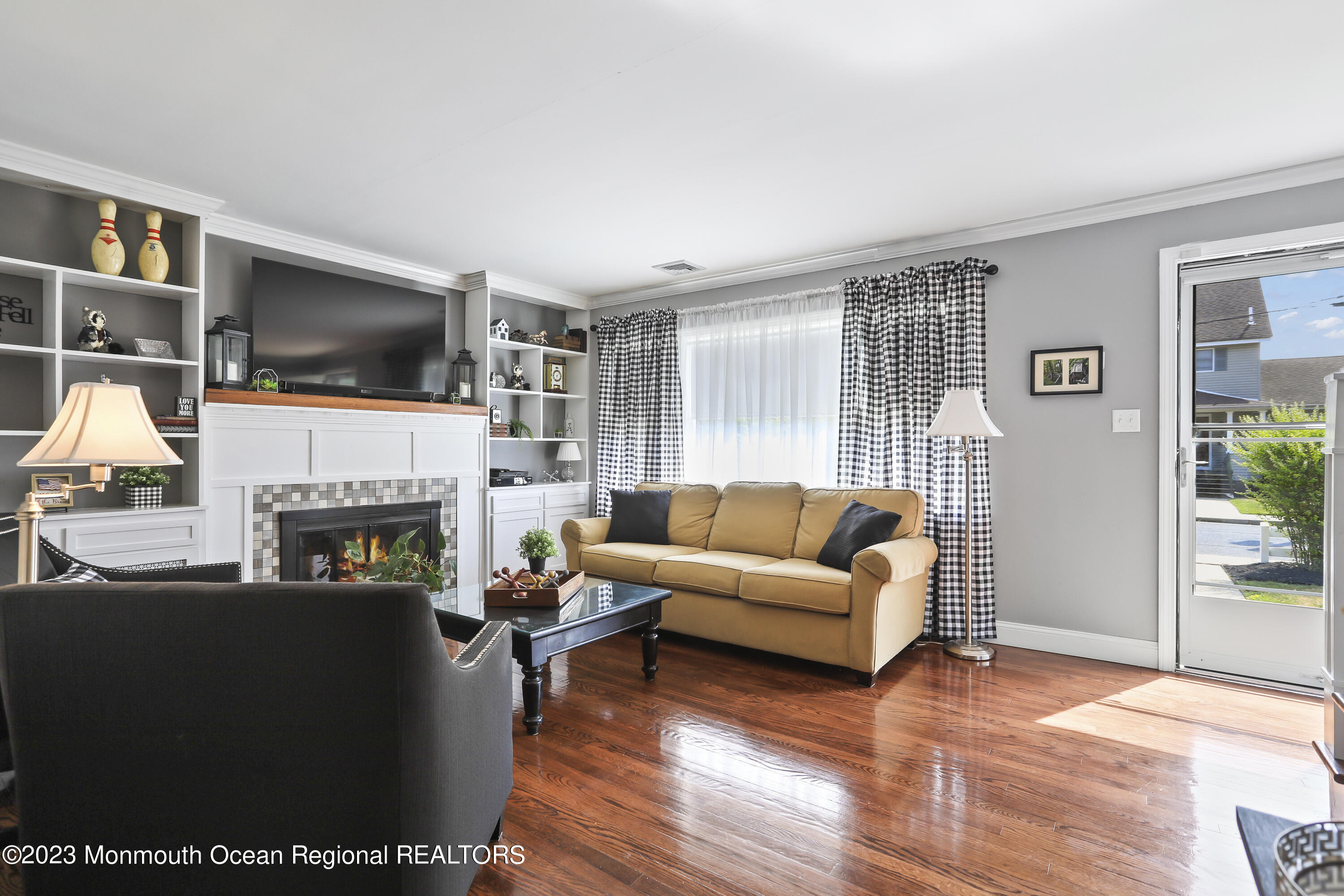 7 Burtina Place Keyport, NJ 07735 - Photo 4 of 29 a living room with furniture a flat screen tv and a fireplace