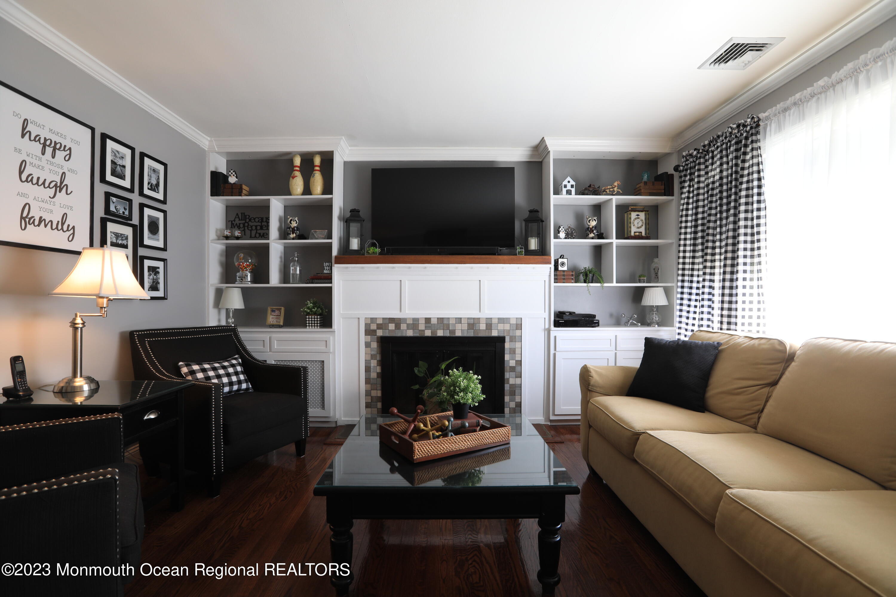 7 Burtina Place Keyport, NJ 07735 - Photo 6 of 29 a living room with furniture a flat screen tv and a fireplace