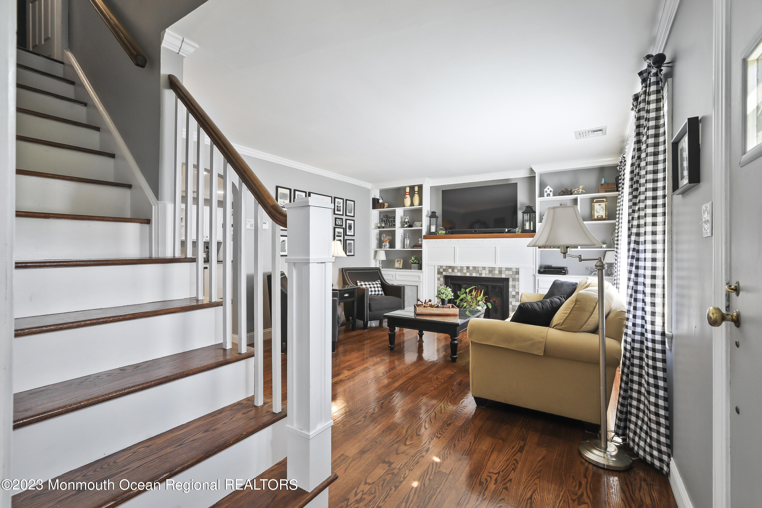 7 Burtina Place Keyport, NJ 07735 - Photo 7 of 29 a living room with furniture a fireplace and a flat screen tv