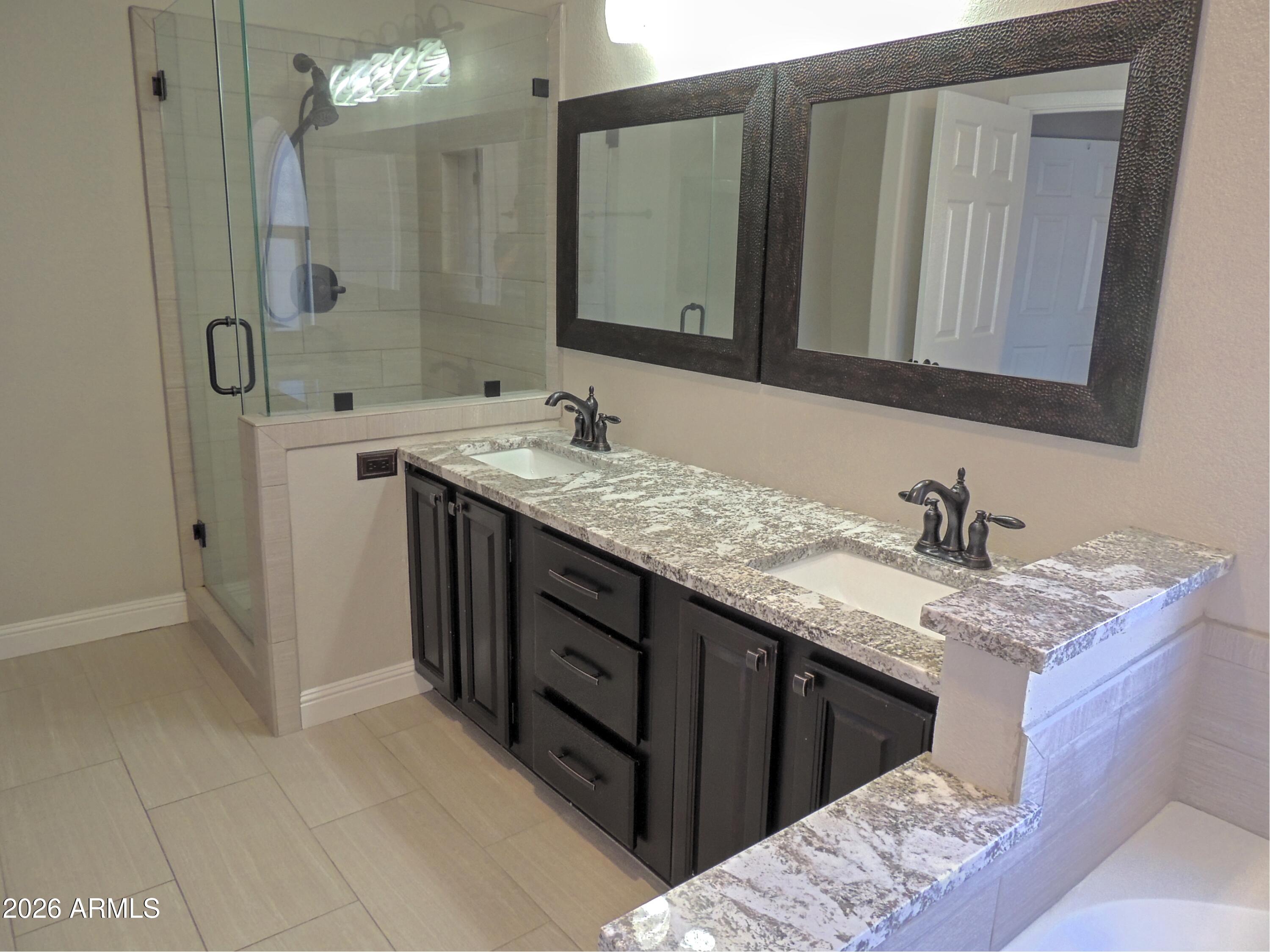 4409 East Dry Creek Road Phoenix, AZ 85044 - Photo 19 of 34 a bathroom with a granite countertop sink and a mirror