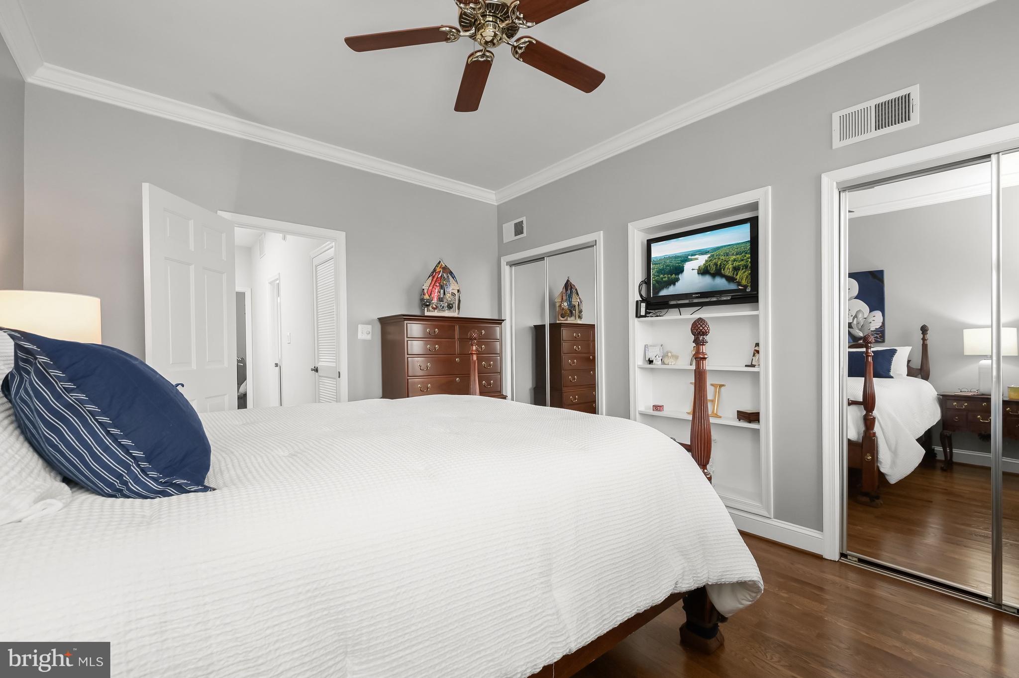 237 10th Street Southeast Washington, DC 20003 - Photo 17 of 40 a bedroom with a bed and a chandelier