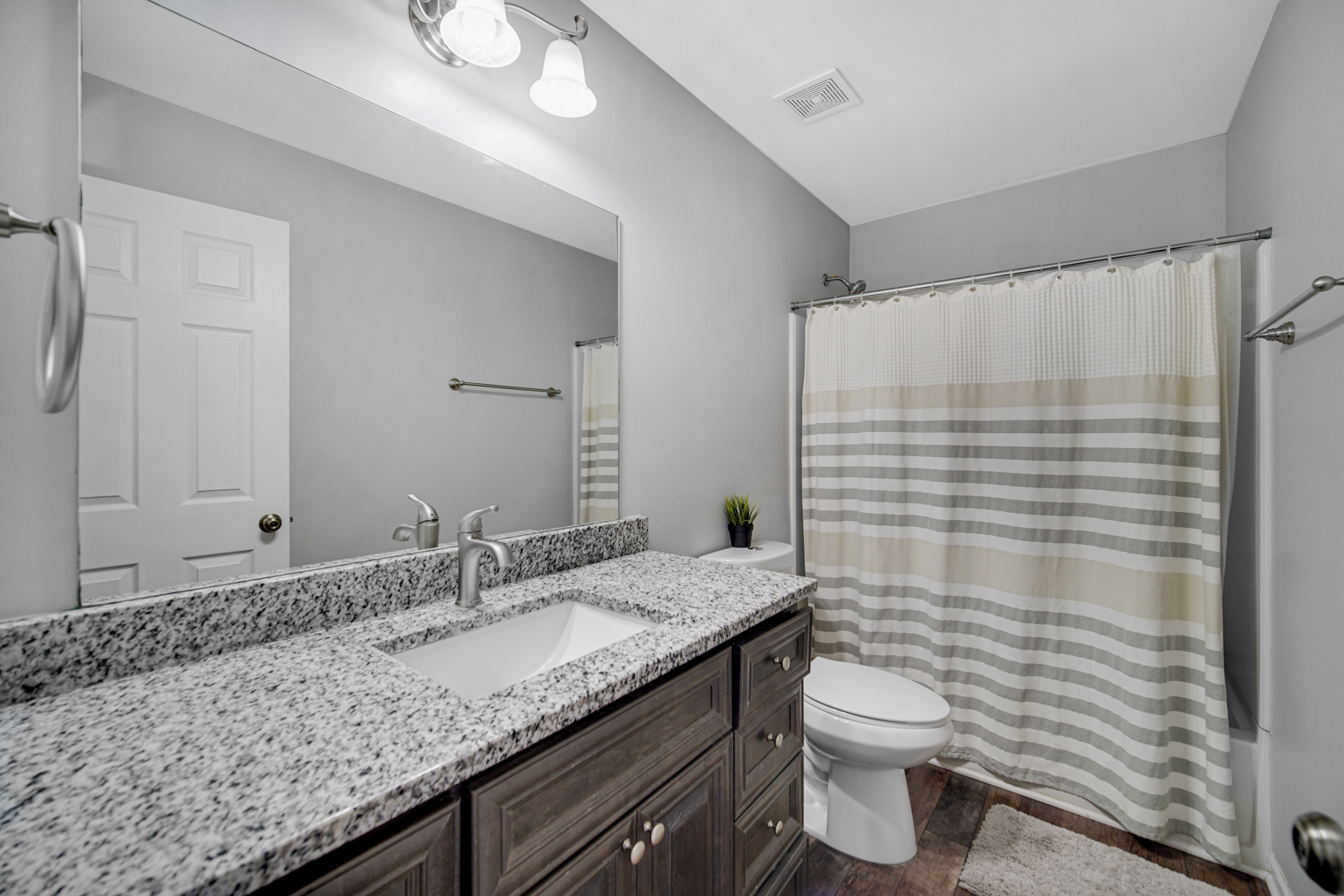 1741 Raleigh Trail Romeoville, IL 60446 - Photo 16 of 20 a bathroom with a granite countertop sink a toilet and shower curtain