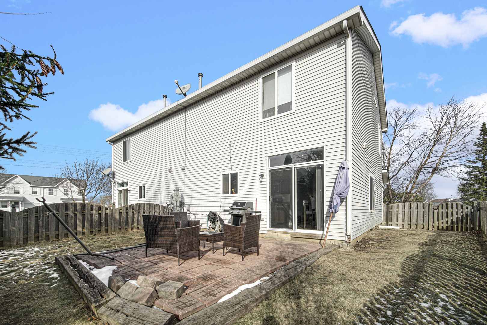 1741 Raleigh Trail Romeoville, IL 60446 - Photo 4 of 20 a view of a patio with a dining table and chairs with wooden fence
