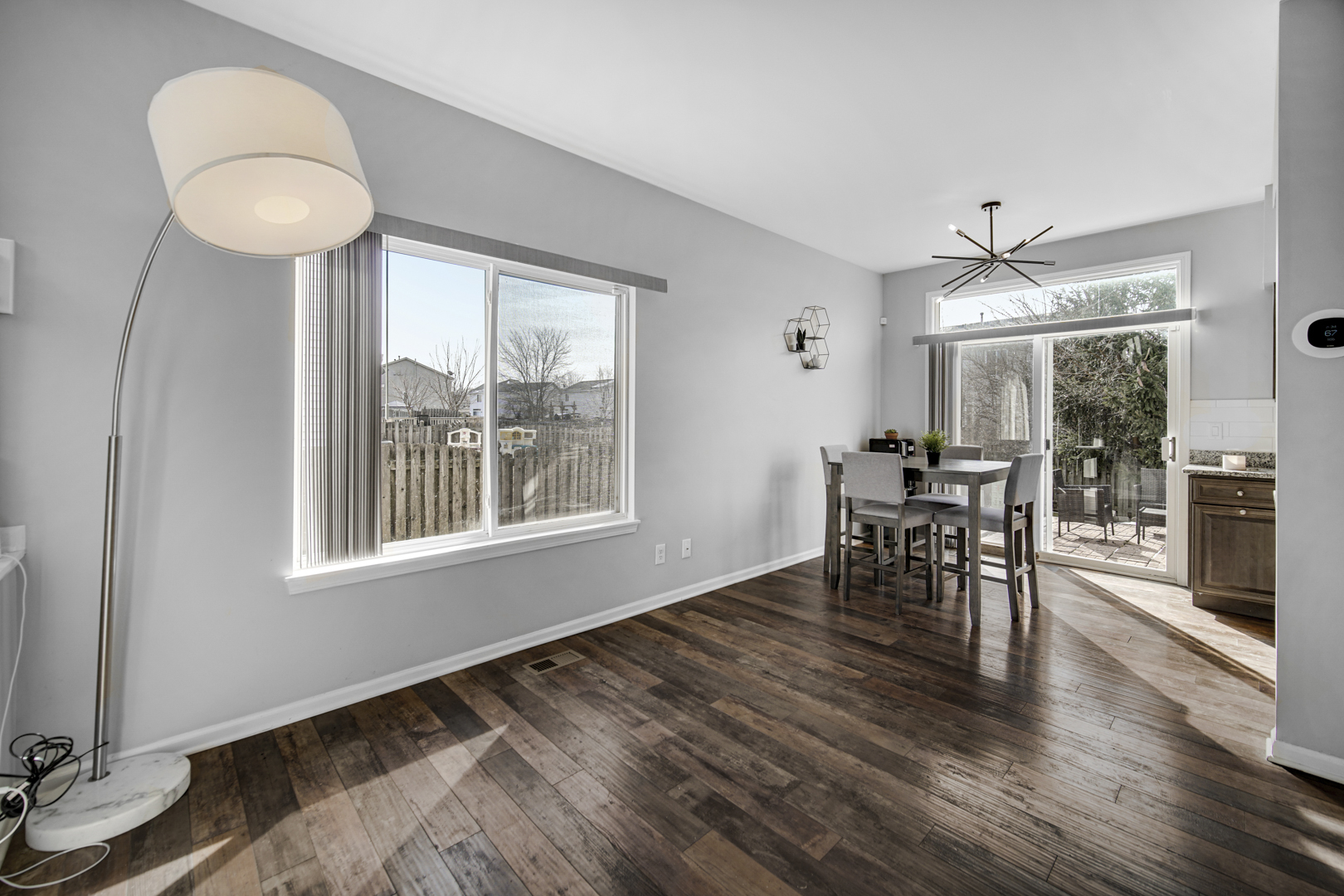 1741 Raleigh Trail Romeoville, IL 60446 - Photo 7 of 20 a dining room with wooden floor a chandelier a wooden table and chairs