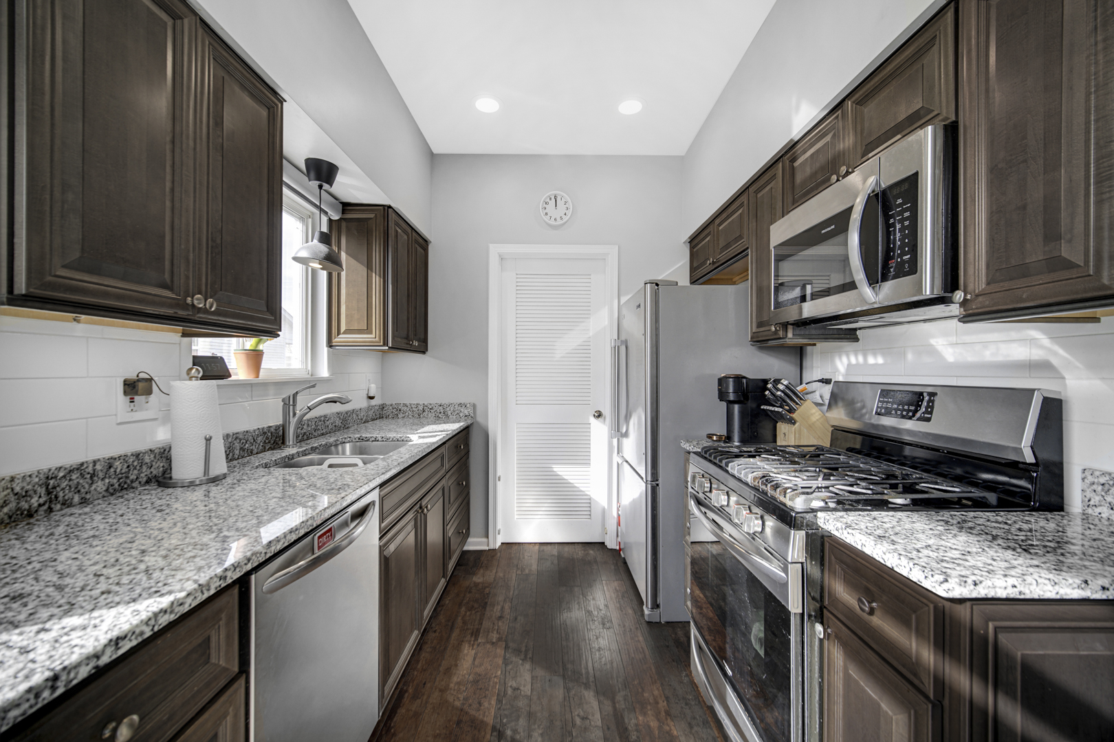1741 Raleigh Trail Romeoville, IL 60446 - Photo 10 of 20 a kitchen with stainless steel appliances granite countertop a stove microwave and sink