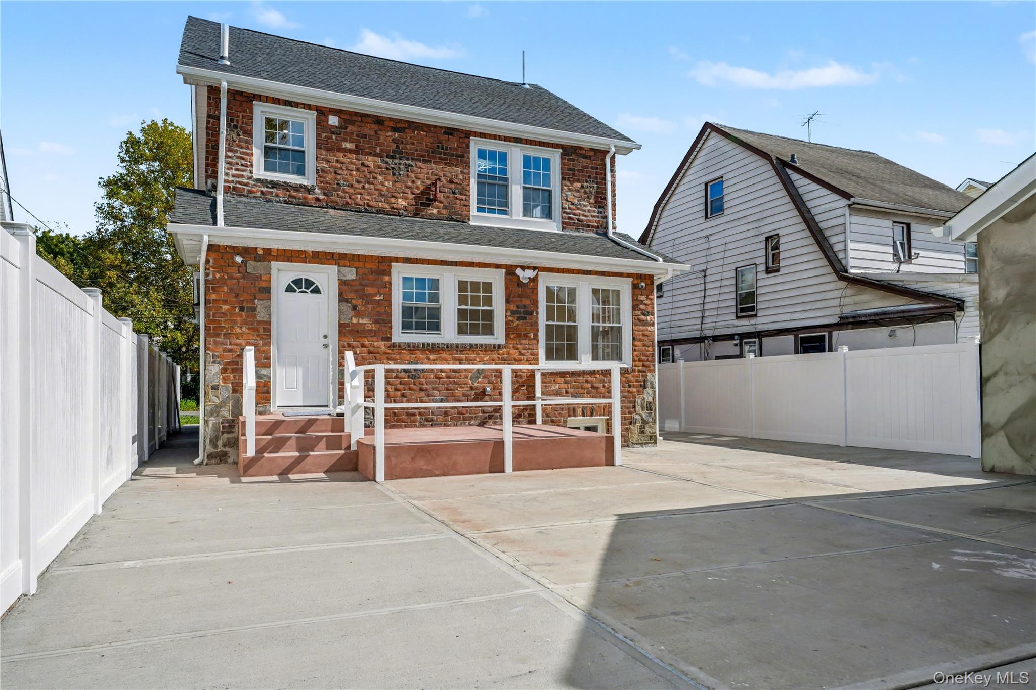 104-40 194th Street Queens, NY 11412 - Photo 17 of 18 a view of a house with a large window and stairs