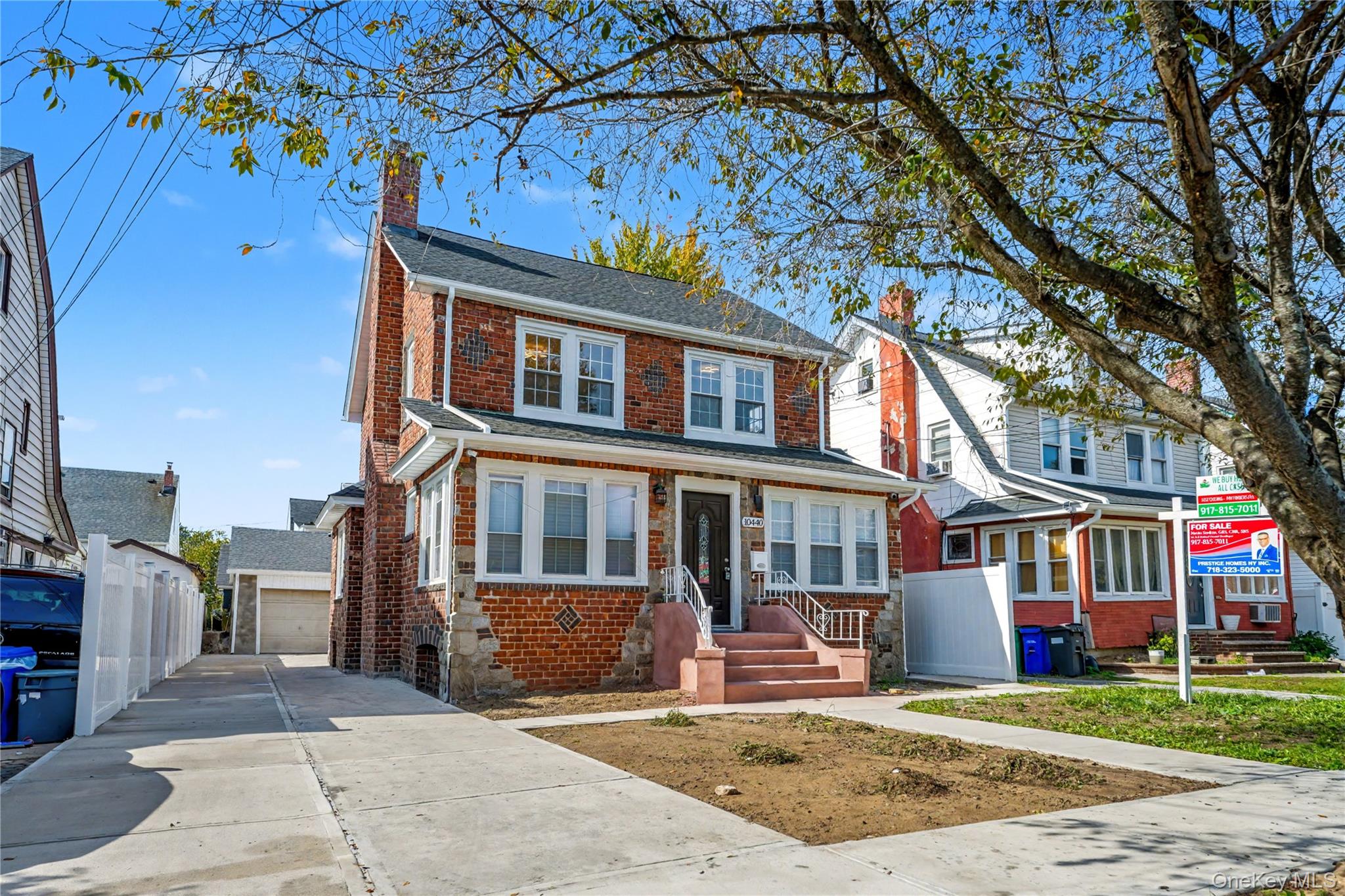 104-40 194th Street Queens, NY 11412 - Photo 2 of 18 a front view of a house with a garden and tree