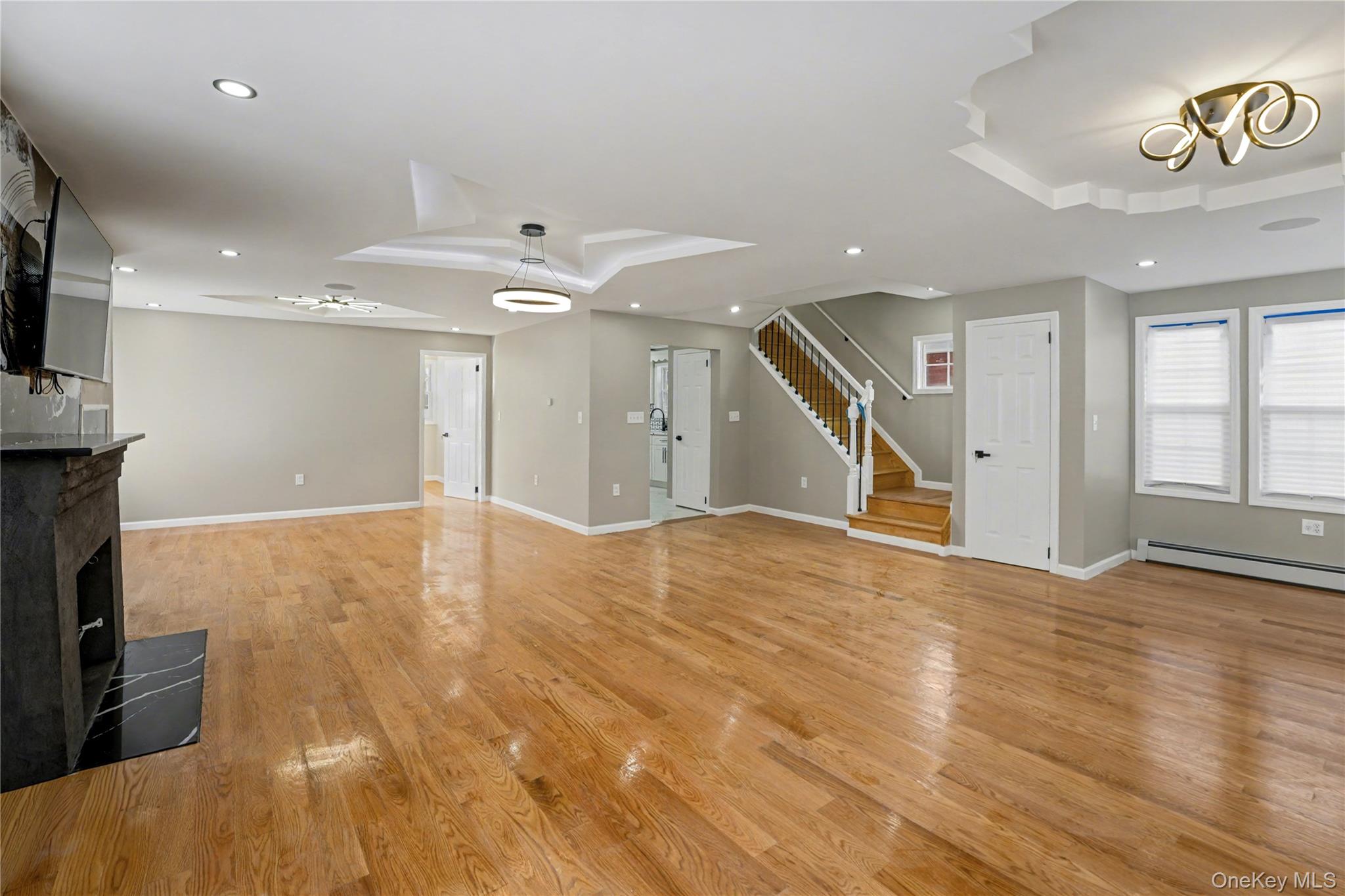 104-40 194th Street Queens, NY 11412 - Photo 5 of 18 a view of an empty room with wooden floor and a window