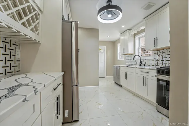 a kitchen with a stove a sink and a refrigerator