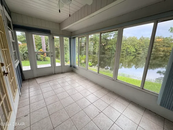a view of a room that has a large window and front view