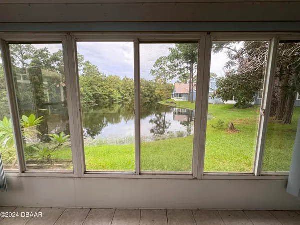 a view of backyard of house with green space