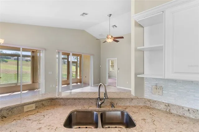 a bathroom with a granite countertop sink mirror and bathtub