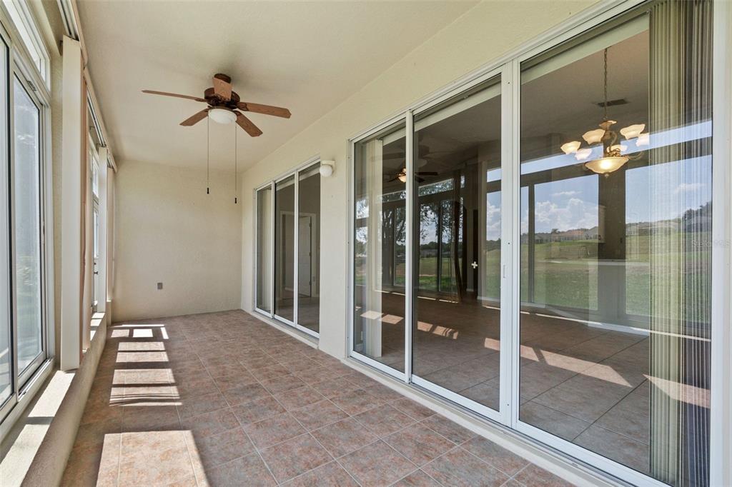 890 Summit Greens Boulevard Clermont, FL 34711 - Photo 34 of 62 a view of a hallway with a glass door and chandelier