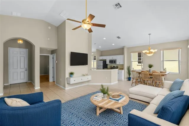 a kitchen with stainless steel appliances kitchen island granite countertop a refrigerator a stove a sink and a sink