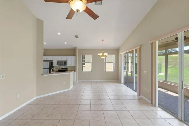 a kitchen with granite countertop a refrigerator and a sink
