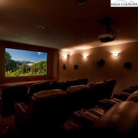 a media room with lots of chairs and a projector screen