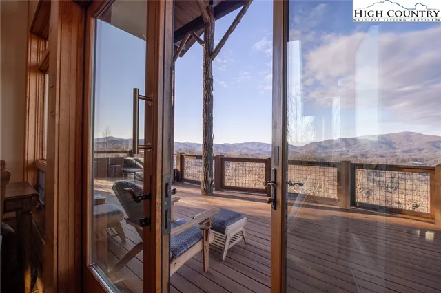 a view of a balcony with chairs and wooden floor
