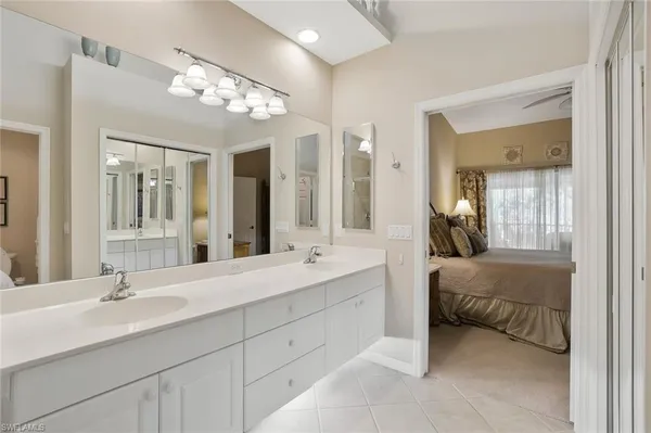 a bedroom with two large bed and a flat tv screen on dresser