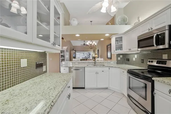 a kitchen with stainless steel appliances granite countertop a stove and cabinets